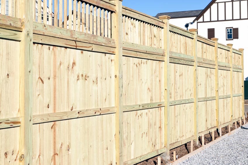 Fence made of pressure treated wood for outdoor areas