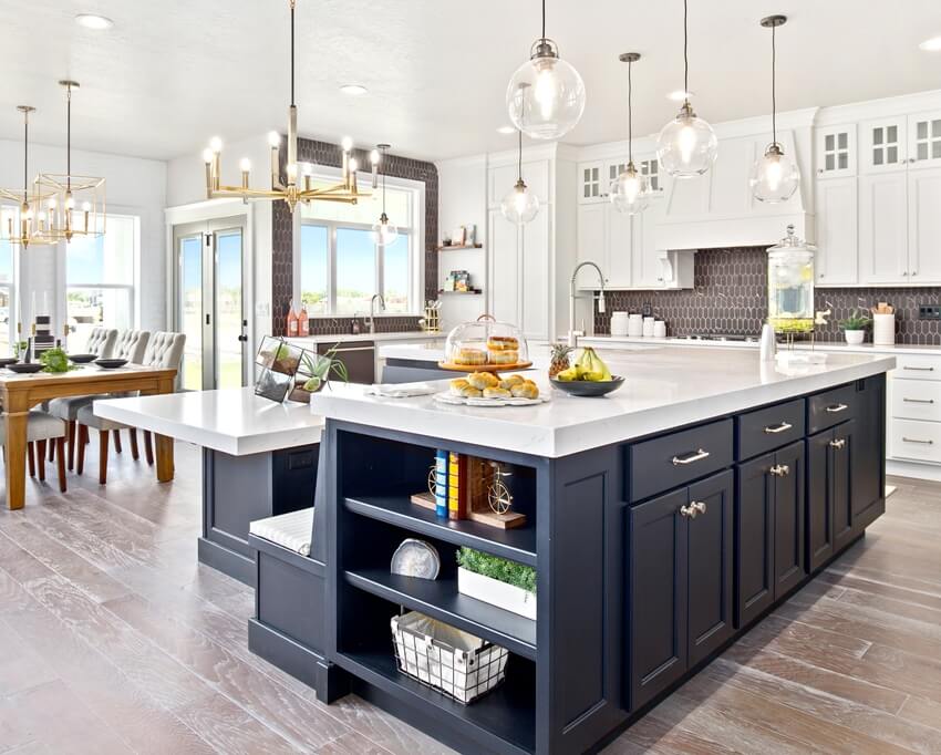 Kitchen showcasing ultra compact countertop, large island with attached bench and dining table 