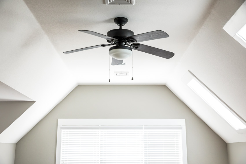 Home interior with white walls, windows, and ceiling fan