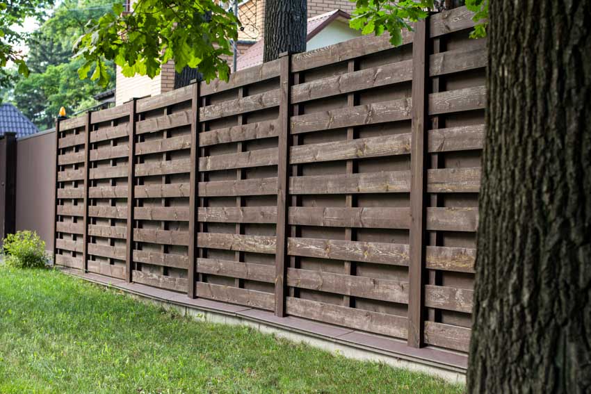 Horizontal shadow box fence made of wood for house exteriors