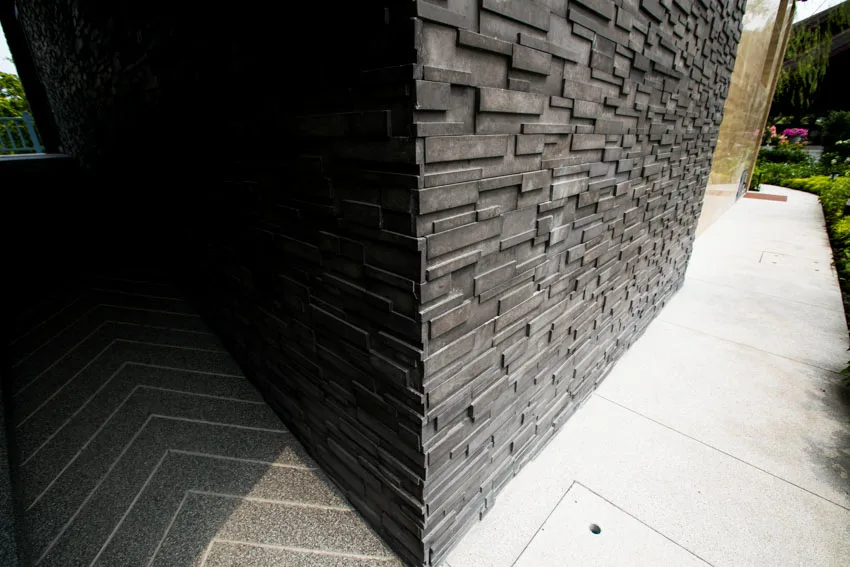 A closeup of an onyx siding, and patterned tile flooring