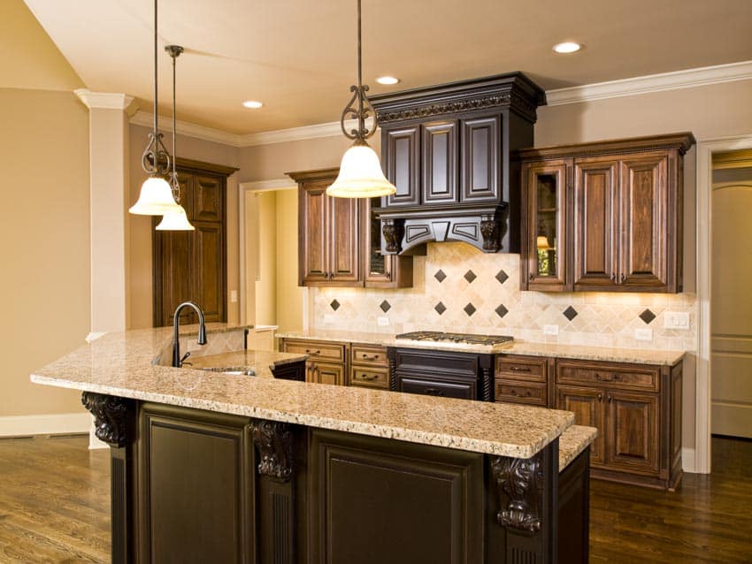 Kitchen with bar counter, backsplash, wood cabinets, pendant lighting fixtures, and stove