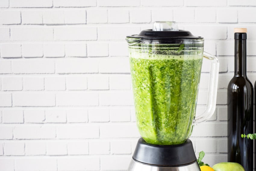 Green juice inside a blender