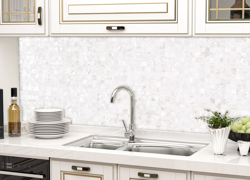 Kitchen with double sink, peel and stick backsplash, piled plates and wine bottle