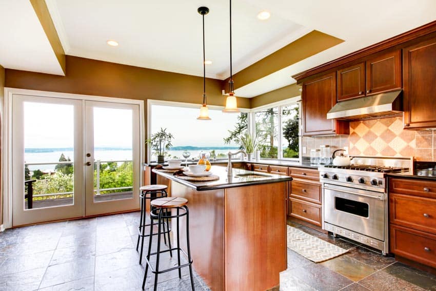 Kitchen with double door, picture window, white ceiling and hanging lights