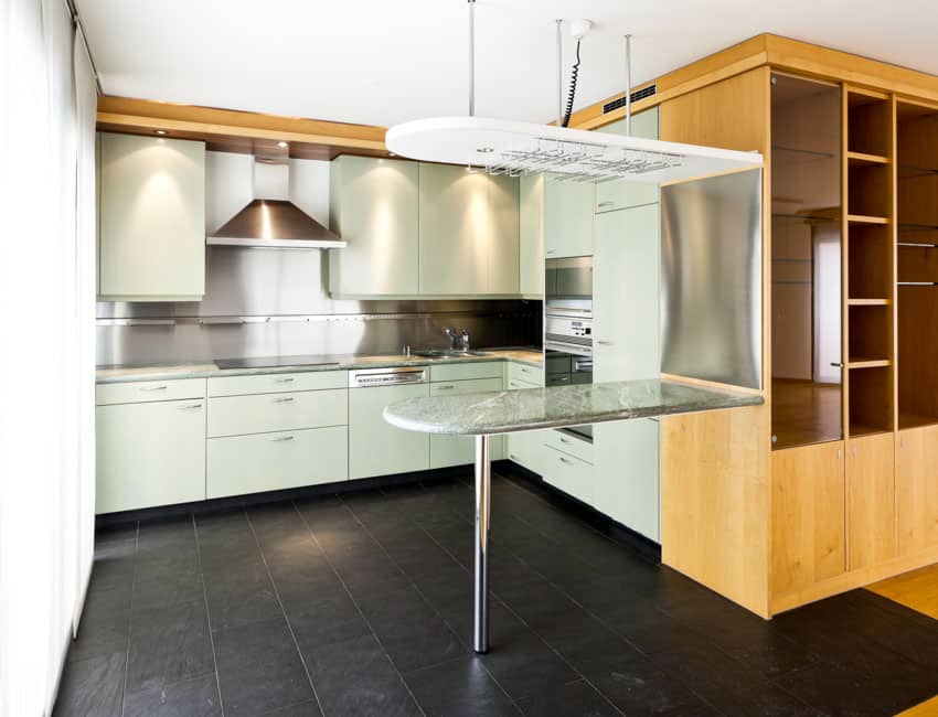 Kitchen with white cabinets and glass countertop