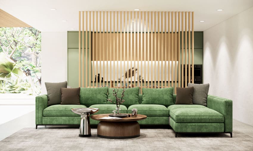 Living room with wood slat divider wall, green sofa, and coffee table