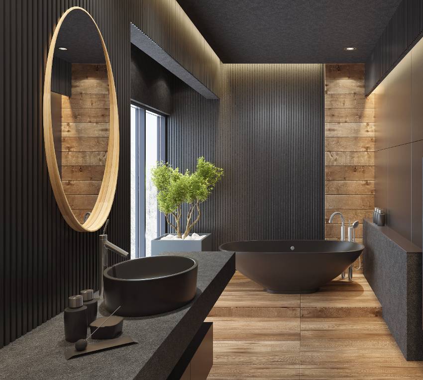A luxurious modern bathroom with black leathered granite countertop against semi glossy surface walls, black bathtub and wooden floors