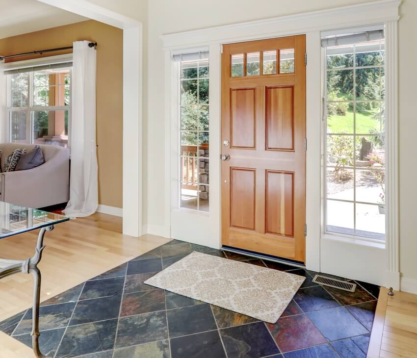 Main door entrance hallway with wooden door and blue stone tiles