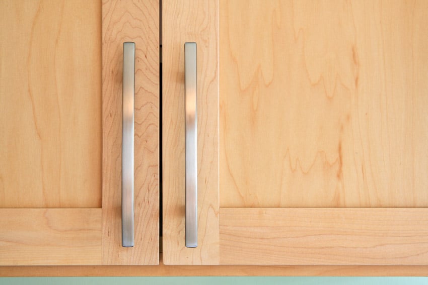 Metal handles on wooden cabinet doors