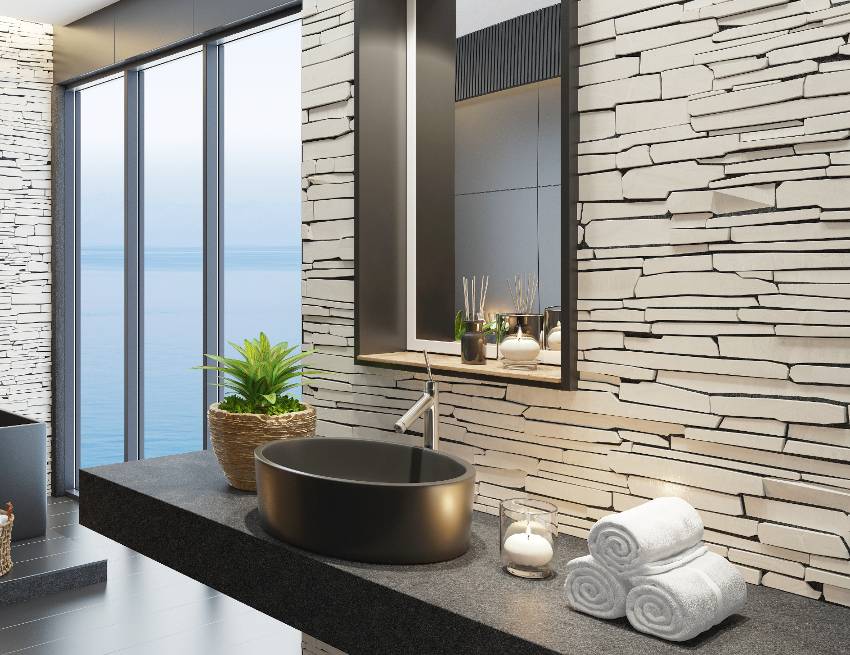 Modern Asian themed bathroom with leathered black granite countertop and glossy black ceramic vessel sink