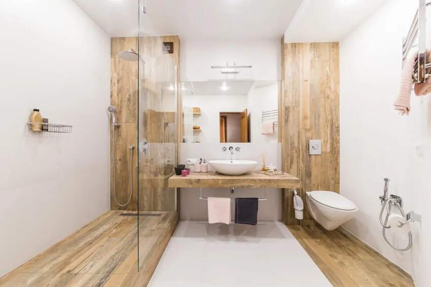 A modern bathroom interior combined with toilet and shower room with white paint and laminate walls