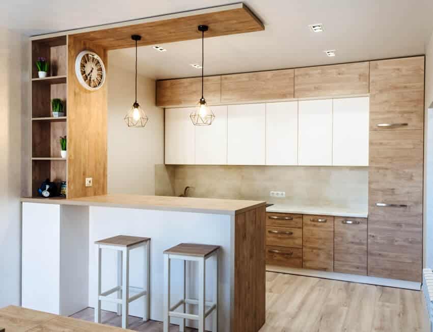 Modern bright kitchen interior with wooden floors, bar with stool and white counters, grade c teak cabinets and back tiles