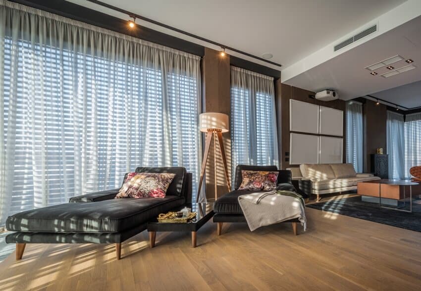Living space in a luxury penthouse apartment with floating vinyl plank flooring and beautiful dark tone furnitures