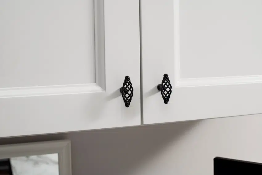 Novelty knobs on white cabinet 