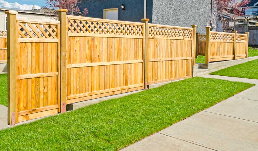 Outdoor area with pressure treated fence, grass, and walkway