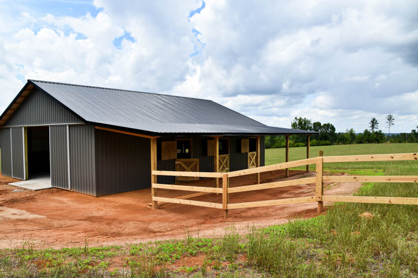 Gray barn with cedar fence