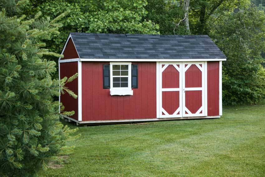Outdoor shed with red paint, doors, window, and pitched roof
