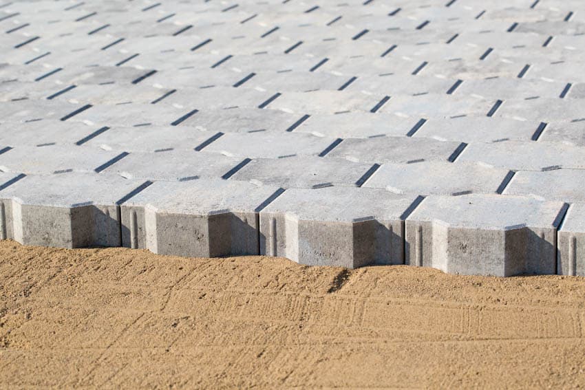 Paver sand base with concrete interlocking pavers on top of it