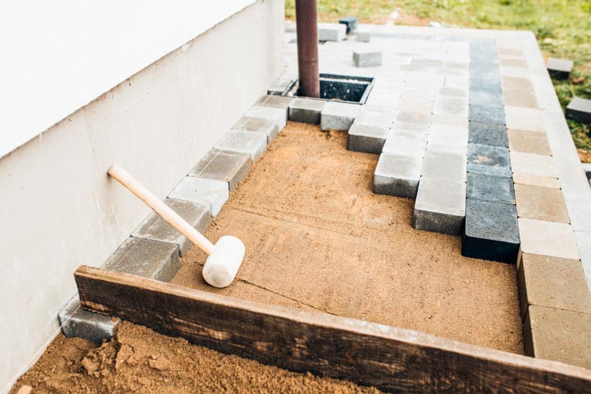 Pavers being constructed on a raised base