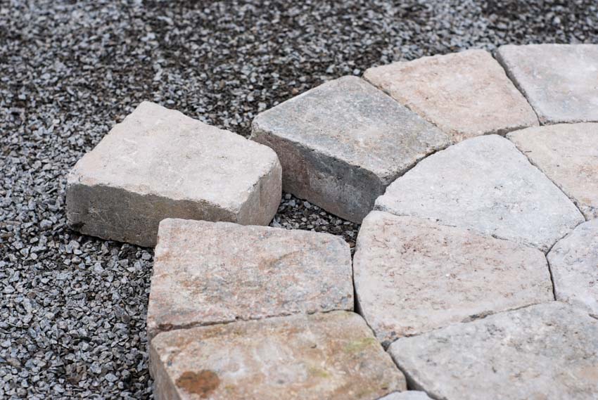 Fan shaped paver being installed