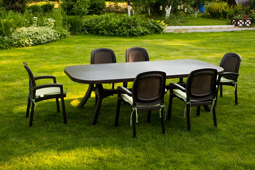 Plastic chairs and table on outdoor grass