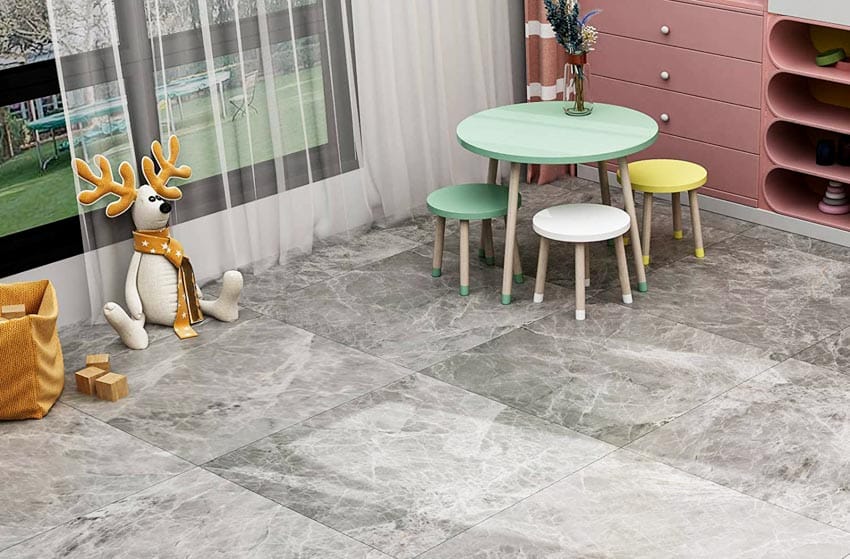 Playroom with green table, colorful chairs, and peel and stick tiles