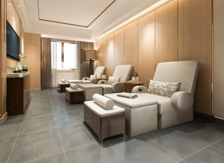 A relaxing spa room with comfortable massage chairs and soapstone flooring