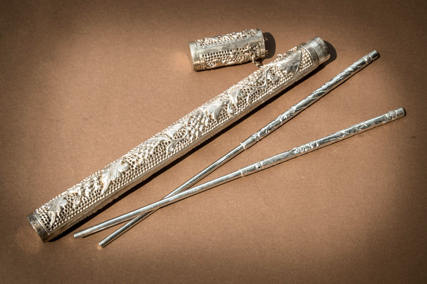 Silver chopsticks and container for dining purposes
