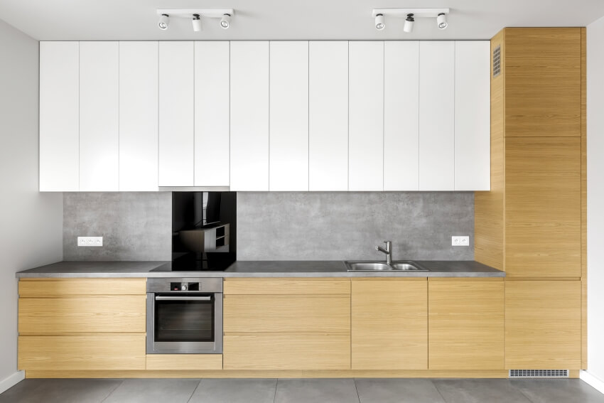 A simple kitchen design with wooden cabinets, granite countertop with cement skim coat and white cupboards