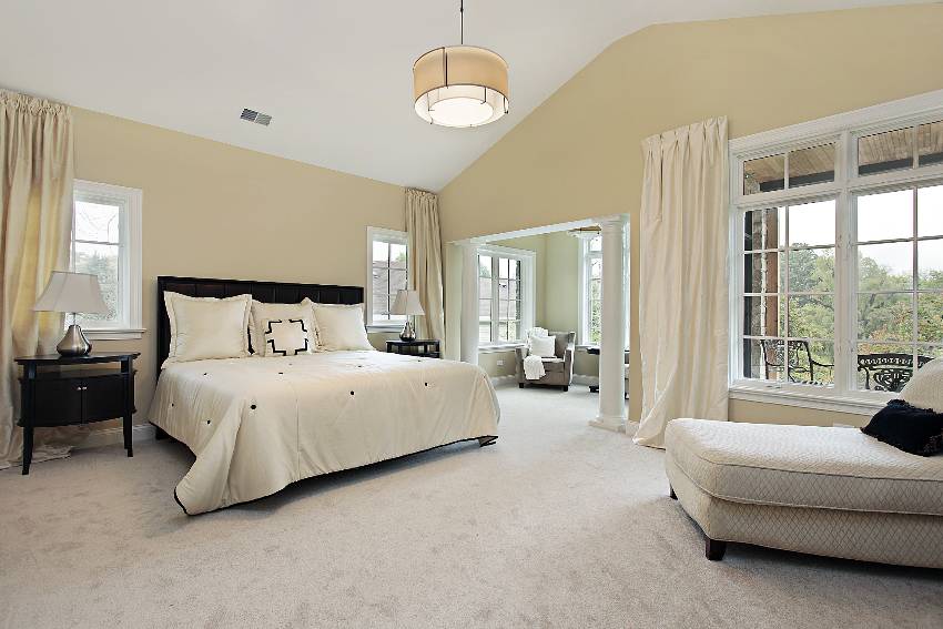 Large bedroom with carpet and sitting room