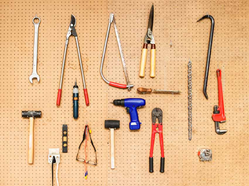 Tools hanging on a pegboard for shed organization