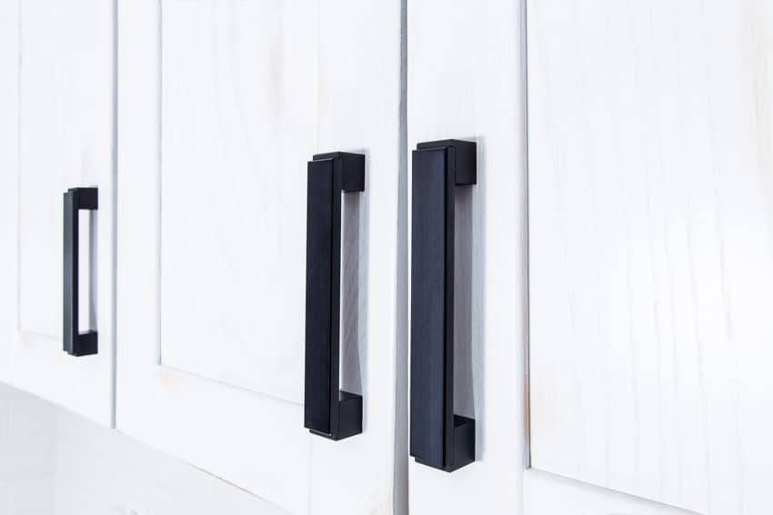 Transitional cabinet hardware with black handles