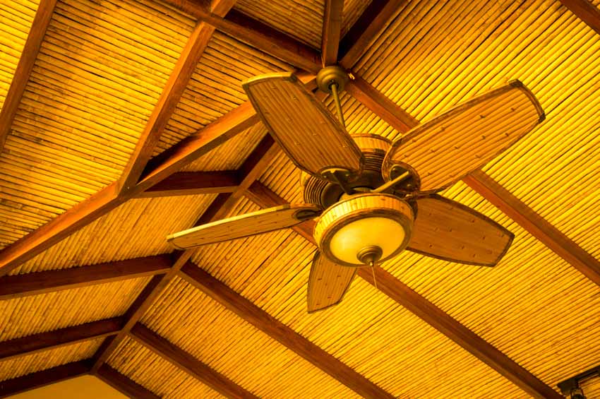 Wood slat ceiling with ceiling fan and lighting fixture