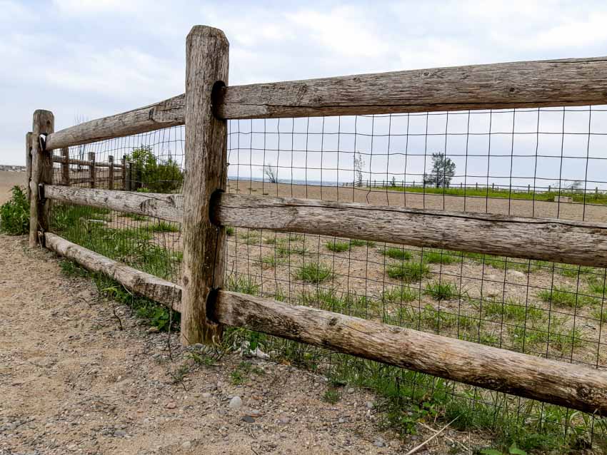 Wooden split rail fence with wire mesh for outdoor areas