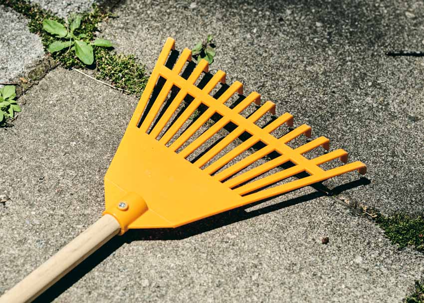 Yellow rake for outdoor spaces and landscaping purposes