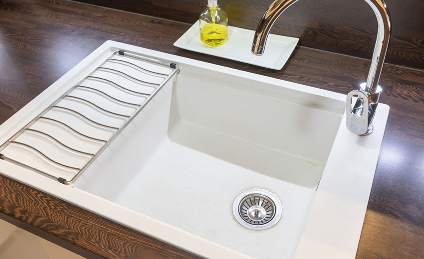 Enamel sink on wooden countertop with standard single handle faucet