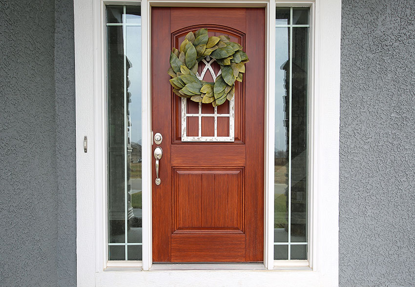 Front door with glass sidelights gray cement textured wall