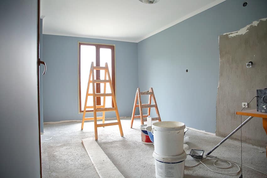 Newly painted room blue paint A-frame wooden ladder