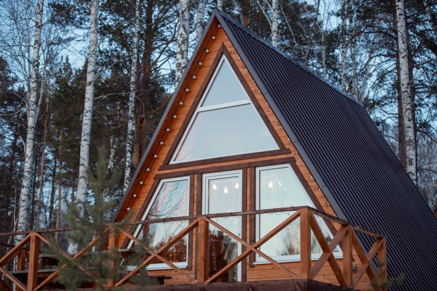 A-frame tiny house exterior with glass windows and pitched roof
