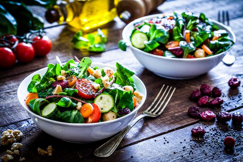 A pair of salad bowls and a fork 