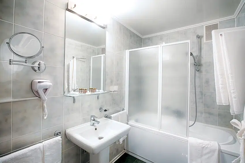 Bathroom with bathtub sink with partition door and shower 