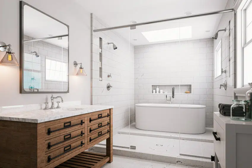 Bathroom with separate shower and bathtub areas and wood cabinets with black handles 