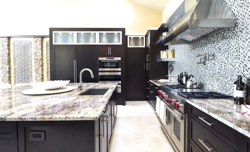 Beautiful modern kitchen with fantasy brown granite countertops and mosaic tile backsplash