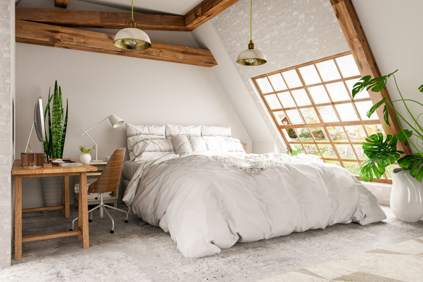 Bedroom with cotton bedding, table, chair, window, exposed ceiling beams, and ceiling lights