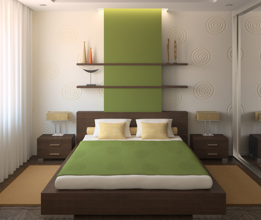 Bedroom with green accent wall, shelves, nightstand, lamps, pillows, and window curtain