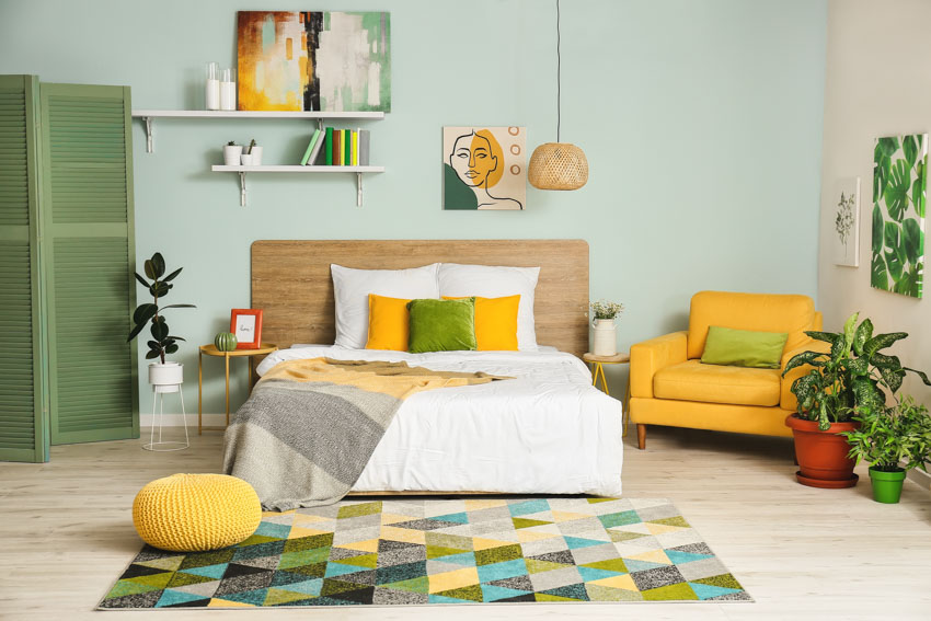 Room with green divider, yellow chair and yellow ottoman