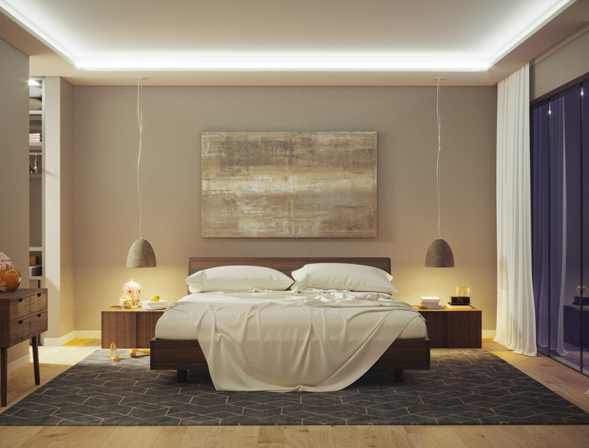 Bedroom with taupe walls, nightstands, lamps, rug, curtains, and wood flooring