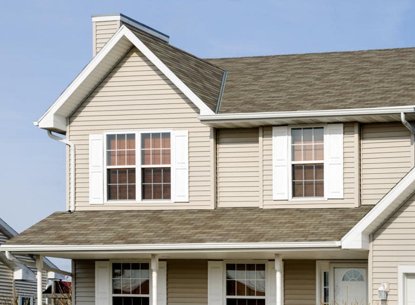 Brown cream exterior with windows, chimney, and siding