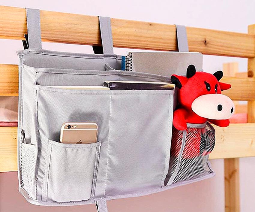 Gray bed caddy with red stuffed toy